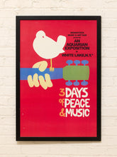 Load image into Gallery viewer, Framed Woodstock 3 Days of Peace and Music poster with white dove, colorful guitar graphic, and red background
