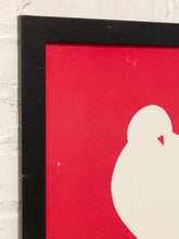 Load image into Gallery viewer, A close-up of a framed art print featuring a bold red background with a large white abstract silhouette, set against a white brick wall.
