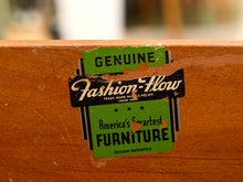 Load image into Gallery viewer, A close-up of a vintage-style wooden furniture label reading 'Genuine Fashion-How' and 'America's Smartest Furniture' applied to a warm brown wooden surface.
