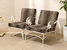 Load image into Gallery viewer, Vintage lounge chair with brown and black leopard print upholstery, white sculptural frame, and curled scroll arms
