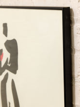 Load image into Gallery viewer, Close-up of a framed art print with a minimalist black silhouette figure on a warm off-white background, leaning against a white brick wall.
