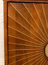 Load image into Gallery viewer, Close-up of a wooden cabinet door featuring a sunburst inlay design with radiating light wood lines on a medium brown wood background.
