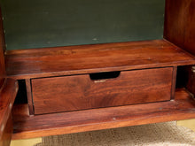 Load image into Gallery viewer, A close-up of a wooden furniture piece showing a reddish-brown wood drawer with a recessed pull handle, set within a larger wooden cabinet or shelf unit.

