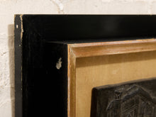 Load image into Gallery viewer, A close-up of a vintage framed art piece, showing a distressed black painted frame with a natural wood inner border and a beige mat board, mounted on a white brick wall.
