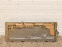 Load image into Gallery viewer, A distressed, vintage-style rectangular metal frame with peeling paint, showing a brown cardboard backing and a gray polka-dotted fabric lining, set against a white brick wall and woven rug.
