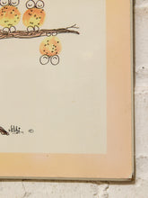 Load image into Gallery viewer, A close-up of a vintage art print featuring whimsical hand-drawn owls perched on a branch, with a cream background and a warm peach border, shown against a white brick wall.
