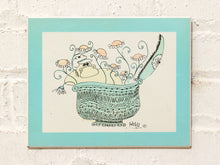 Load image into Gallery viewer, Vintage Hildi illustration of a whimsical hippo surrounded by flowers in an ornate patterned vessel with turquoise mat
