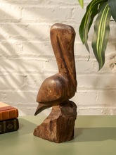 Load image into Gallery viewer, Hand-carved wooden pelican bird sculpture perched on a rustic natural wood base
