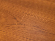 Load image into Gallery viewer, A close-up of a medium brown wood grain surface with a light-colored scratch or mark running diagonally across the center.
