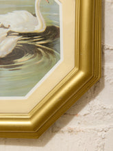 Load image into Gallery viewer, Close-up of a framed artwork showing part of a white swan painting with rippling water, set in a gold frame against a white brick wall.
