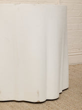 Load image into Gallery viewer, A close-up of a white textured fabric or wallpaper roll draped over a surface, with a beige carpet and white brick wall in the background.
