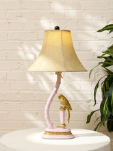 Load image into Gallery viewer, Vintage table lamp with sculptural pink stand, perched golden bird and large flared fabric shade
