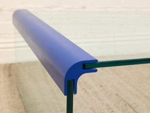 Load image into Gallery viewer, Close-up of a blue protective glass railing edge with a green metal post and transparent glass panel.
