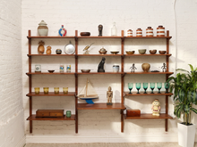 Load image into Gallery viewer, Restored Mid-Century Modern wood wall unit with tall vertical supports and staggered open shelving
