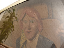 Load image into Gallery viewer, A close-up of a vintage painted wooden panel or door featuring a portrait of a person with pink hair, wearing a yellow patterned necktie and gray jacket. The surface shows reflections of a plant and a hand, indicating it is mounted on a glass window.
