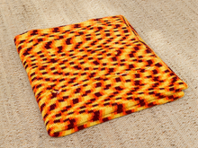 Load image into Gallery viewer, Vintage 1970s crochet afghan blanket in yellow, orange, and brown geometric pattern with chunky handmade texture.
