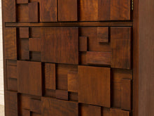 Load image into Gallery viewer, Close-up of a dark brown wooden cabinet or drawer front with a geometric, raised block pattern.
