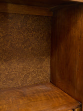 Load image into Gallery viewer, Close-up of a wooden shelf or cabinet interior with a textured brown back panel and warm wood grain.
