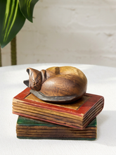 Load image into Gallery viewer, Vintage hand-carved wooden Siamese cat sleeping on a stacked collection of red green and brown carved books
