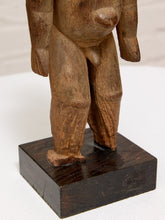 Load image into Gallery viewer, A close-up of a carved wooden figurine showing the lower torso and legs of a nude human form, mounted on a dark rectangular wooden base against a plain light background.
