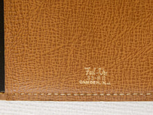 Load image into Gallery viewer, Close-up of a textured tan leather surface with a small embossed logo reading 'Full-Vue' and 'CAMDEN, N.J.
