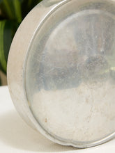 Load image into Gallery viewer, A close-up of the bottom of a vintage cast iron skillet, showing a heavily seasoned, stained interior surface with a faint embossed 'Dupont' brand logo.
