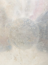 Load image into Gallery viewer, A close-up of a translucent, frosted aluminum surface with embossed text reading 'Important: Always Heat Your Aluminum Hot Water Bottle to the Los'.
