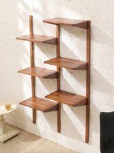 Load image into Gallery viewer, A mid-century modern wooden wall shelf with five tiers, mounted on a white brick wall in a room setting.
