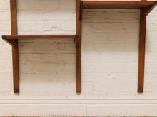 Load image into Gallery viewer, A pair of mid-century modern wooden wall shelves mounted on a white-painted brick wall.

