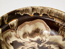 Load image into Gallery viewer, Close-up of a ceramic bowl interior with a glossy marbled pattern in dark brown and cream, showing the dripping glaze along the rim.
