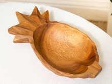 Load image into Gallery viewer, A carved wooden bowl shaped like a pineapple, resting on a white textured tablecloth.
