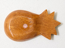 Load image into Gallery viewer, A hand-carved wooden pineapple-shaped object, likely a decorative piece or tool, shown on a textured white fabric background.
