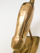 Load image into Gallery viewer, A close-up of a polished brass sculpture showing its reflective metallic surface and smooth curved form against a plain white background.
