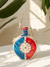 Load image into Gallery viewer, Vintage round leather-wrapped decanter with red blue and cream hand-stitched geometric decoration
