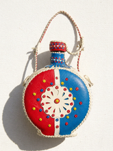 Load image into Gallery viewer, Vintage round leather-wrapped decanter with red blue and cream hand-stitched geometric decoration

