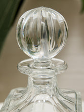 Load image into Gallery viewer, A close-up of a clear glass decanter with a faceted, ribbed spherical stopper, set against a softly blurred neutral background.
