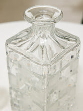 Load image into Gallery viewer, A clear glass decanter with a faceted, textured body and a short flared neck, shown on a light surface.
