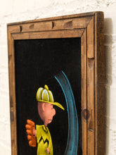 Load image into Gallery viewer, A framed art print featuring a stylized cartoon ball player in a yellow uniform and striped helmet on a black background, enclosed in a rustic wooden frame and mounted on a white brick wall.
