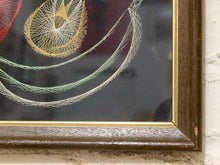 Load image into Gallery viewer, Close-up of a framed abstract string art piece with yellow, green, white, and red lines on a dark background, set in a dark wood frame with a gold inner trim.
