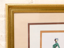 Load image into Gallery viewer, Close-up of a framed art print showing a textured gold frame, cream matting, and a partial illustration of a woman in a green dress.
