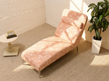 Load image into Gallery viewer, Vintage chaise lounge with peach and cream palm leaf upholstery, rounded back, and matching bolster cushion

