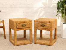 Load image into Gallery viewer, Pair of vintage woven rattan nightstands with drawers, brass-tone bail pulls and open lower shelves
