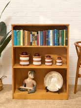 Load image into Gallery viewer, Vintage light wood bookcase with three open shelf levels, natural wood grain, and compact rectangular silhouette
