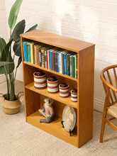 Load image into Gallery viewer, Vintage light wood bookcase with three open shelf levels, natural wood grain, and compact rectangular silhouette

