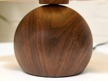 Load image into Gallery viewer, Close-up of a spherical wooden lamp base with a rich dark brown wood grain finish, resting on a light surface.
