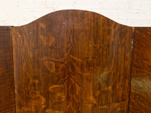Load image into Gallery viewer, Close-up of a dark brown wooden panel with a curved top arch and visible wood grain, set against a white brick wall background.

