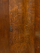 Load image into Gallery viewer, Close-up of a polished dark brown wooden door with prominent wavy grain patterns and a small ornate metal keyhole on the left side.
