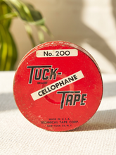 Load image into Gallery viewer, Vintage red Tuck Tape No. 200 cellophane tape round container with black and white advertising graphics
