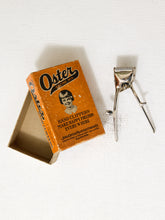 Load image into Gallery viewer, Vintage orange Oster hand clippers advertising box with illustrated portrait and John Oster Manufacturing Co. Racine Wisconsin branding
