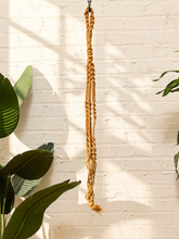 Load image into Gallery viewer, Vintage 1970s natural fiber macramé plant hanger with braided knots, twisted cord details, and tassel

